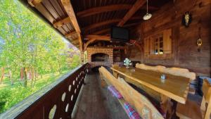 a dining room with a table and chairs and a fireplace at Sekin Vinograd in Voloder