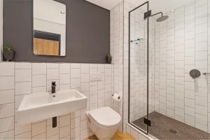 a bathroom with a sink and a toilet and a shower at Nine Palms Studio Retreat Century City in Cape Town