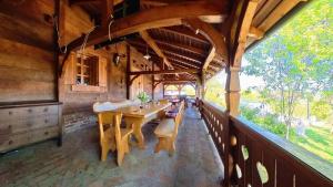 a dining room with a long table in a building at Sekin Vinograd in Voloder