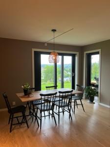 a dining room with a table and chairs at Oppheimhamna 10c in Bø +11 photos