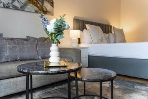 a living room with a couch and a table with a vase at Nine Palms Studio Retreat Century City in Cape Town +20 photos