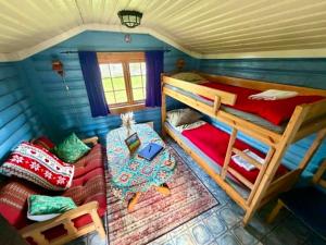 a room with two bunk beds and a couch at Ringen Camping in Vestre Gausdal
