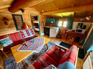a living room with a red couch and a table at Ringen Camping in Vestre Gausdal