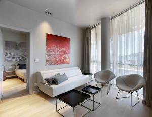 a living room with a white couch and a red painting at Trogir SkyView Suites in Trogir