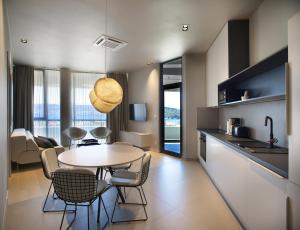 a kitchen and living room with a table and chairs at Trogir SkyView Suites in Trogir