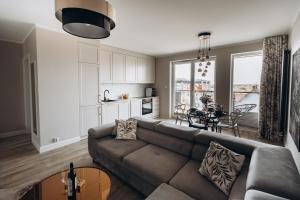 a living room with a couch and a table at Apartament Złote Noce in Augustów