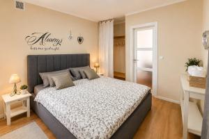 a bedroom with a bed and a desk and a window at Apartment MAGAŠ in Vrbnik +63 photos