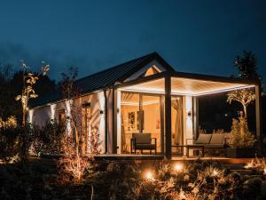 a house with a conservatory at night with lights at Lavendream in Kőröshegy
