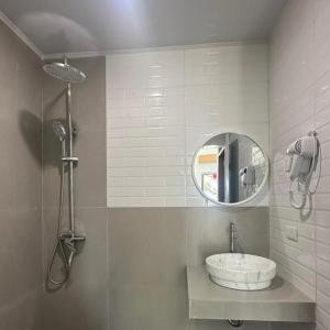 a bathroom with a sink and a mirror at Villa Takasima Berastagi in Berastagi +82 photos
