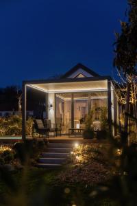 a house with a lit up porch at night at Lavendream in Kőröshegy +34 photos