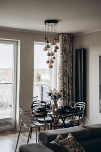 a dining room with a table and chairs at Apartament Złote Noce in Augustów +17 photos