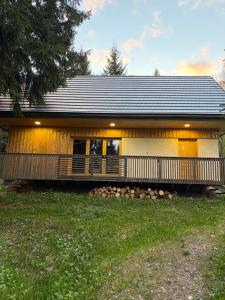a house with a large porch and a porch at Hargitaház Mountain House in Harghita-Băi