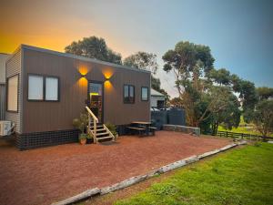 a small house with a patio in a yard at The Tiny Apostle - Great Ocean Road in Princetown