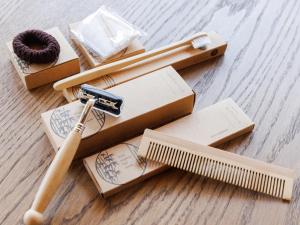 a wooden box with a wooden comb and a wooden stick at Locanda Furanora in Furano