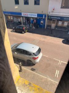 a silver car parked in front of a gas station at Colne Hideaway in Colne