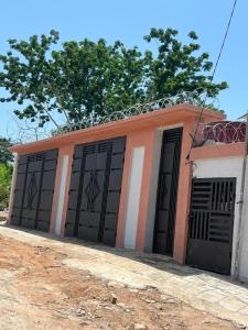 a building with four garage doors on it at CHAMBREs SALON MEUBLÉ in Yamoussoukro