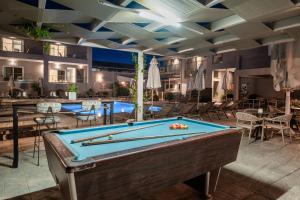 a pool table in the middle of a pool room at Vice Hotel in Laganas
