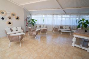 a living room with couches and chairs and a table at BLUESEA Lentiscos in Cala en Blanes