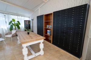 a room with a table and a wall of wine cellar at BLUESEA Lentiscos in Cala en Blanes +19 photos