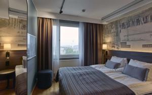a hotel room with a bed and a window at Scandic Opalen in Gothenburg