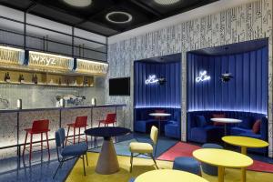a rendering of a restaurant with tables and chairs at Aloft by Marriott Xiamen Xiangan in Xiamen +44 photos