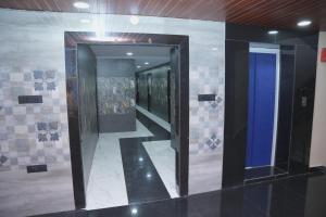 a hallway with a mirror in a building at V Rooms in Pendurti