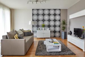 a living room with a couch and a tv at 7Seasons Apartments Budapest in Budapest