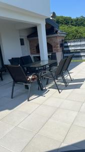 a table and chairs sitting on a patio at Villa Emerald in Šiljkovača