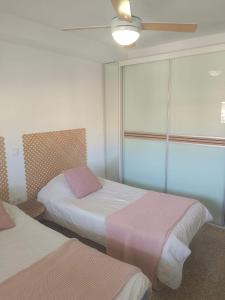 a room with two beds and a window at Marina Tavernes in Tavernes de Valldigna
