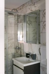a bathroom with a sink and a mirror at Apartmani Dejavu na Drini in Ljubovija +33 photos