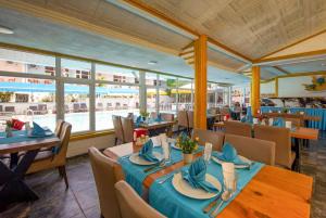 a restaurant with tables and chairs and a view of the ocean at Side Temple Hotel in Side +26 photos