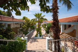 a walkway between two buildings with palm trees at Side Temple Hotel in Side