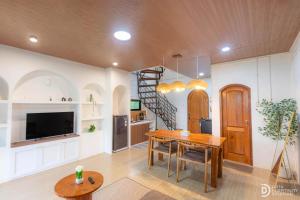 a kitchen and dining room with a table and a staircase at Diamond Cabin 3 in Diyeng