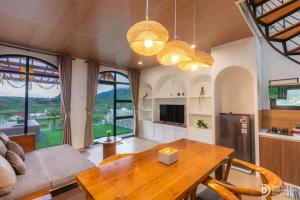 a kitchen and living room with a wooden table at Diamond Cabin 3 in Diyeng