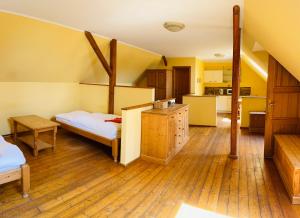 a large room with two beds and a kitchen at Apartmány Na vlně in Kozákov