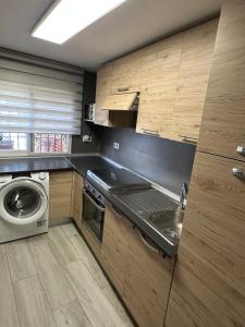 a kitchen with a sink and a washing machine at apartamento peñon de jolucar in Torrenueva