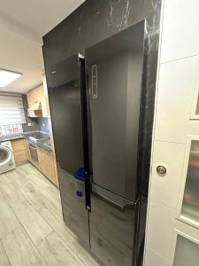 a large black refrigerator in a kitchen at apartamento peñon de jolucar in Torrenueva