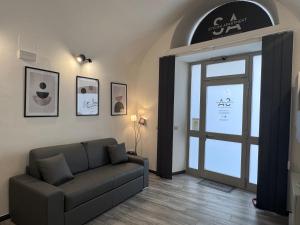 a living room with a couch and a glass door at Norcia Stylish Apartment in Norcia