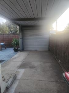 an empty garage with a white garage door at Entire Unit in Brooklyn Park in West Richmond
