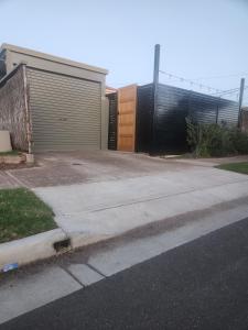 a parking lot with a garage and a fence at Entire Unit in Brooklyn Park in West Richmond