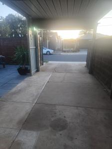 an empty garage with a car parked in a driveway at Entire Unit in Brooklyn Park in West Richmond