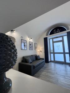 a living room with a couch and a window at Norcia Stylish Apartment in Norcia