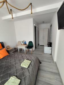a living room with a couch and a table at Pokoje Koral in Mikołajki