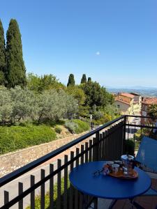 a blue table on a balcony with a view at Casa Dandelle in Gambassi Terme