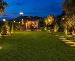 a garden at night with a tent and lights at Olvaya in Bzîza