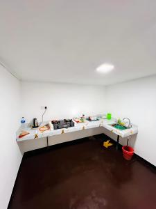 a room with a white counter with a stove at Mandaram Nuwara Sunset Villa in Nuwara Eliya
