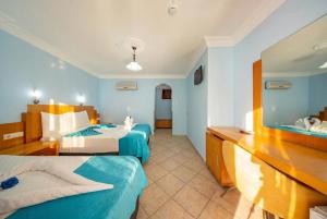 a hotel room with two beds and a sink at Side Temple Hotel in Side