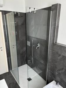 a shower with a glass door in a bathroom at Casa RIGPA in Bellagio +24 photos
