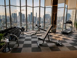 a gym with a checkered floor and a view of a city at Ultra luxury Condo in Bangkok