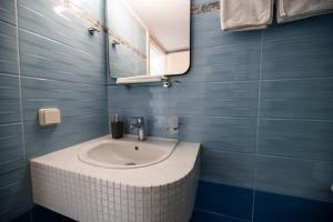 a bathroom with a sink and a mirror at Antonis Studio in Archangelos